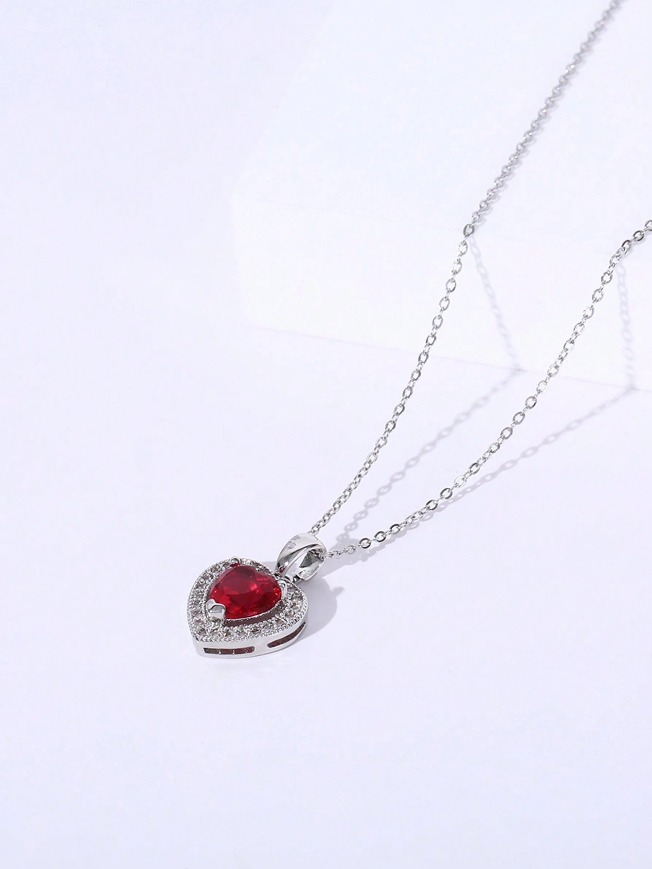 Collar con dije de corazón y piedra roja en acero inoxidable plateado